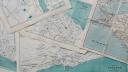 A photo of a stack of old maps. Photo taken by Annie Spratt