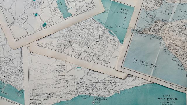 A photo of a stack of old maps. Photo taken by Annie Spratt