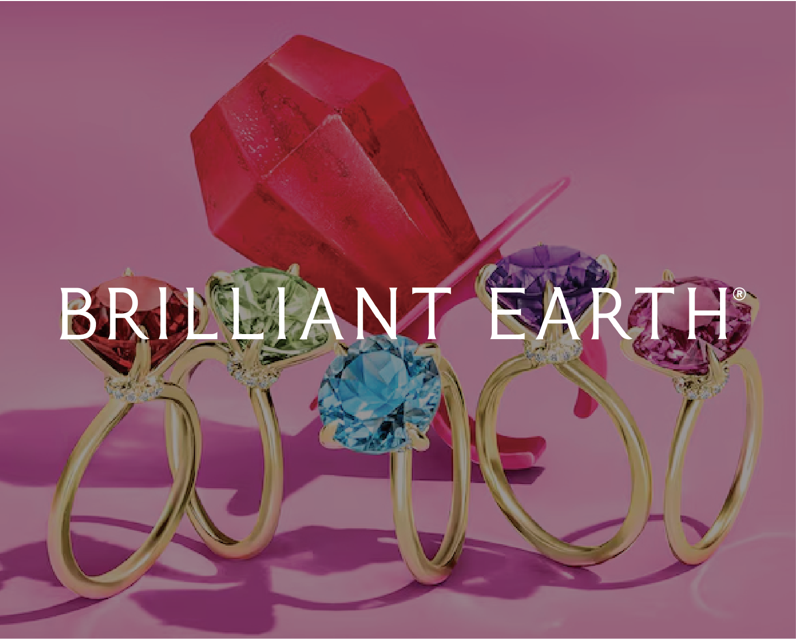 Brilliant Earth logo with rings in the background.